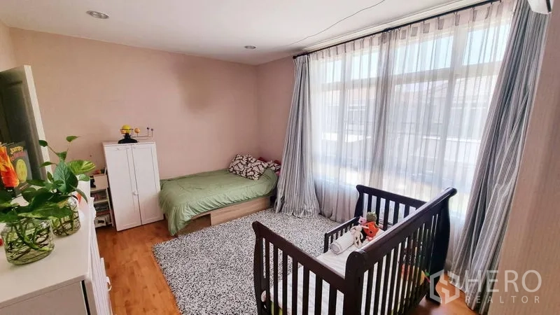 Detached House for rent or sale in Saphan Sung, Bangkok - Family bedroom from another angle showing wardrobe and wide windows.