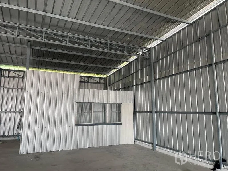 Warehouse for rent in Min Buri, Bangkok - Internal office booth with window inside the metal-panel warehouse.