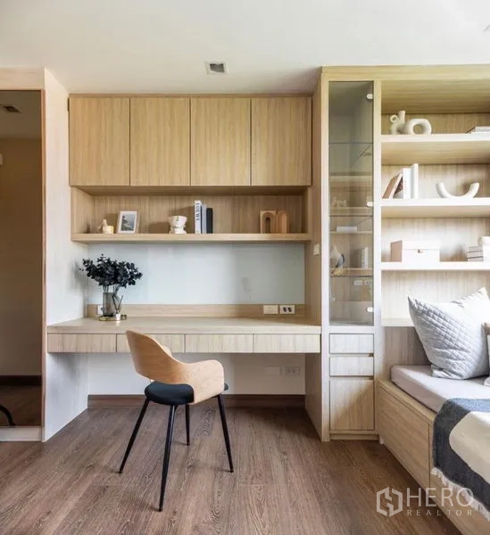 Condominium for rent or sale in Phra Khanong, Bangkok - Built-in wood study area with desk, overhead cabinets and open shelving in a light, modern finish.