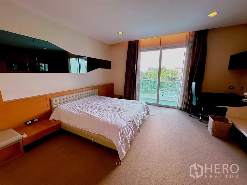 Detached House for rent or sale in Bang Phli, Samut Prakan - Bright bedroom with balcony access, desk and built‑in headboard