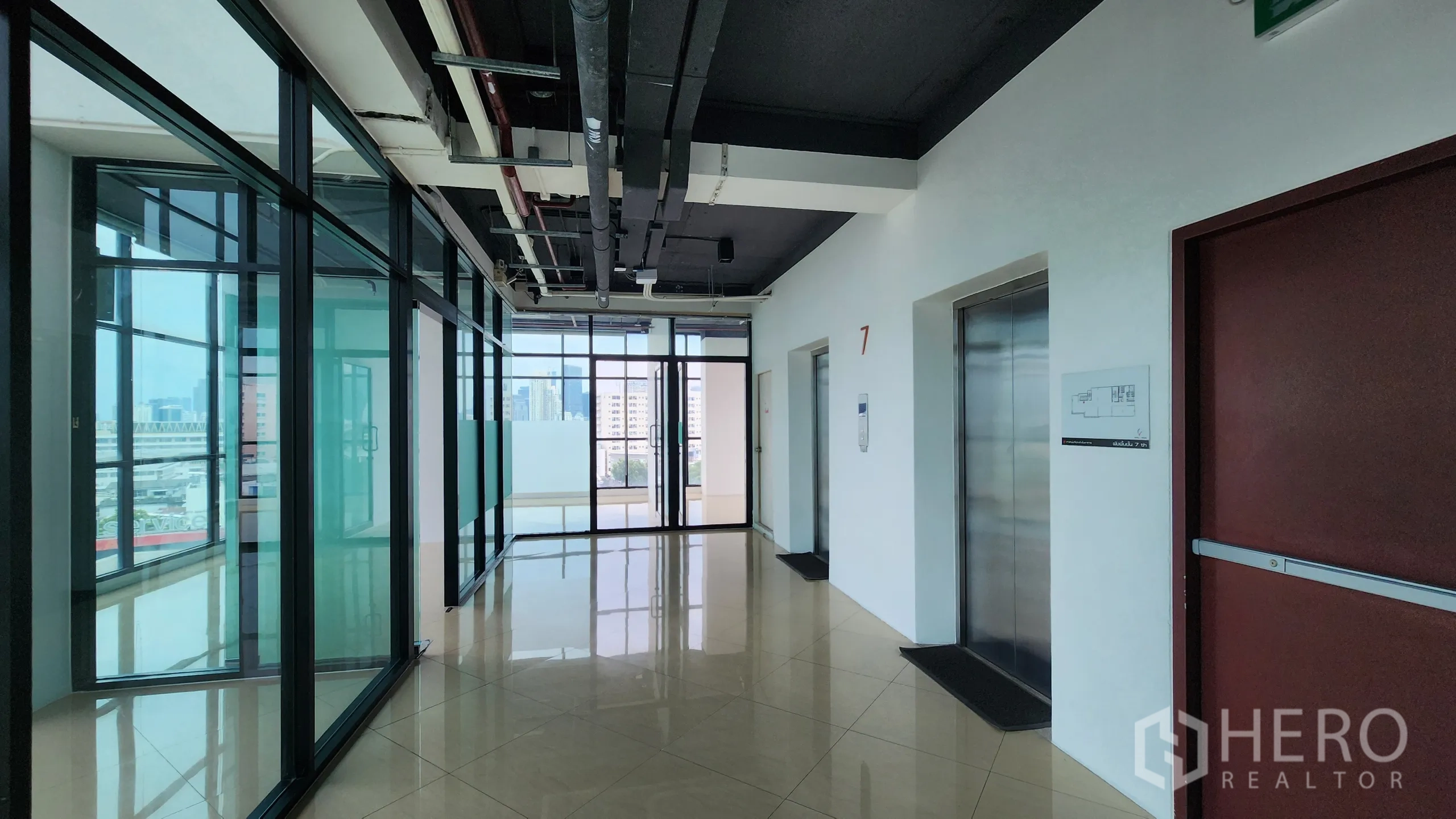 Office Space for rent in Yan Nawa, Bangkok - Elevator hall with glass entry to offices and balcony at end.