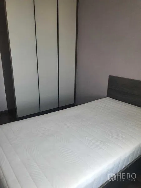 Condominium for rent - Second bedroom with a single bed and floor-to-ceiling wardrobe.