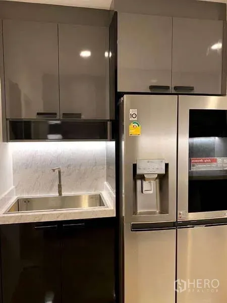 Detached House for rent - Pantry area with stainless sink, tall storage and side-by-side refrigerator with dispenser.