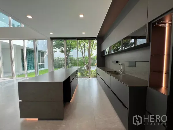 Detached House for sale in Bang Phli, Samut Prakan - Contemporary kitchen with long island, dark cabinetry and garden view