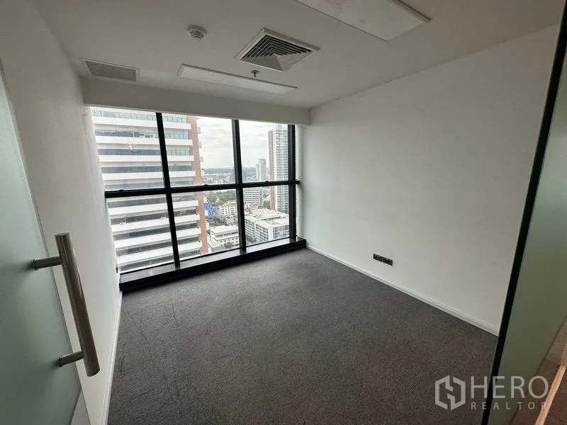 Office Space for rent - Private office room with floor-to-ceiling windows overlooking Bangkok.