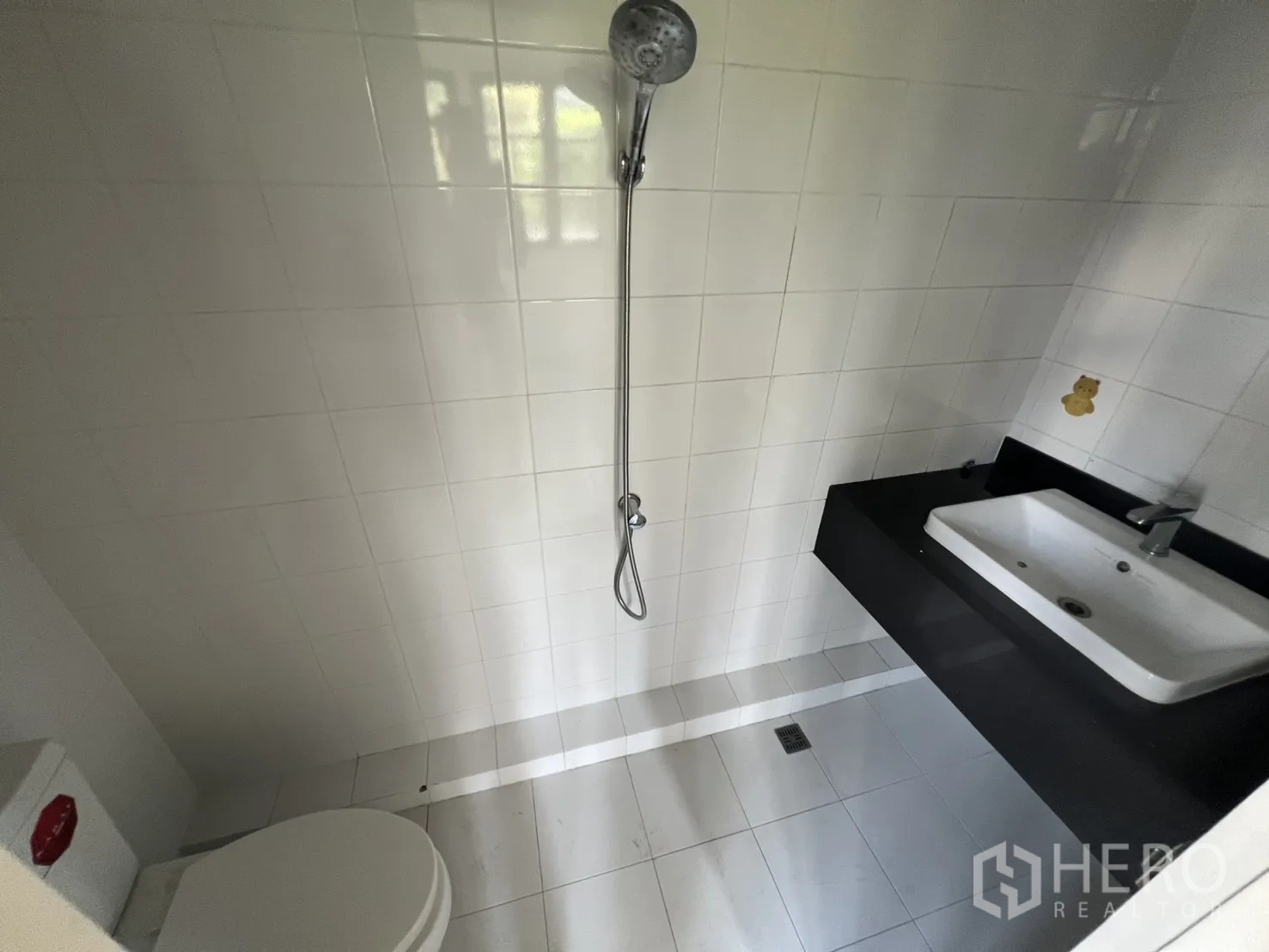店屋 出租在Watthana, Bangkok - 白色瓷砖卫生间，带手持花洒、马桶与长台盆。