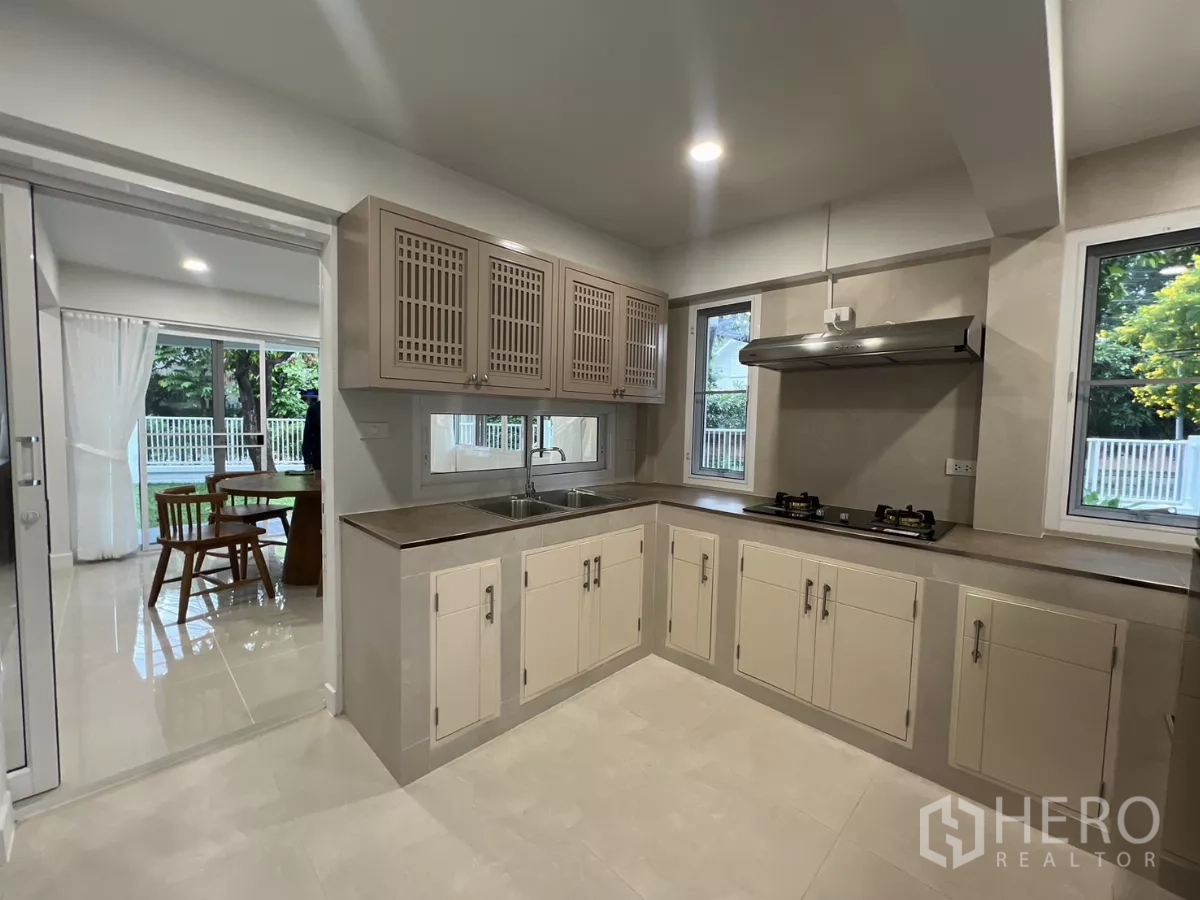 Detached House for rent in Saphan Sung, Bangkok - Kitchen looking toward dining area with sliding partition and ample cabinets.