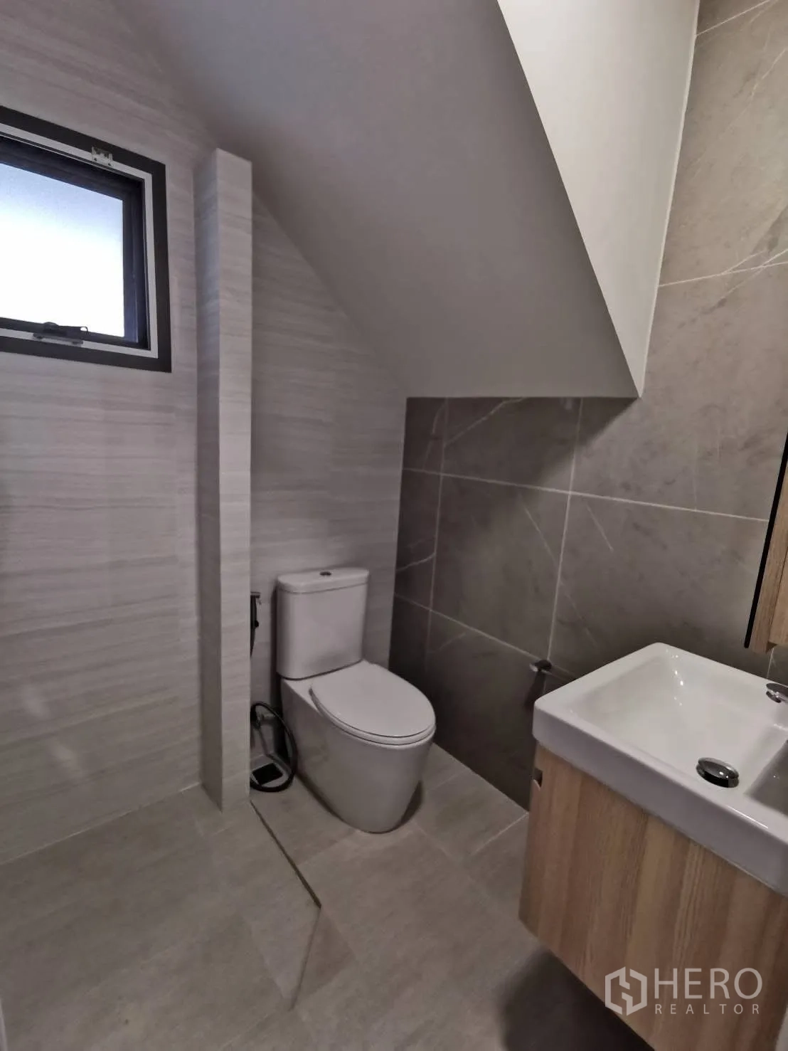 Detached House for rent in Bang Phli, Samut Prakan - Compact under-stair guest bathroom with toilet, sink, and small window.