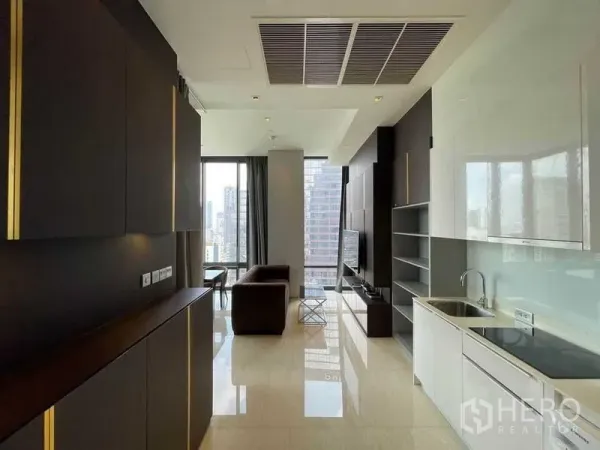 Condominium for rent in Bang Rak, Bangkok - Open-plan Bangkok condo living with sleek kitchen, TV wall and floor-to-ceiling windows overlooking the skyline.
