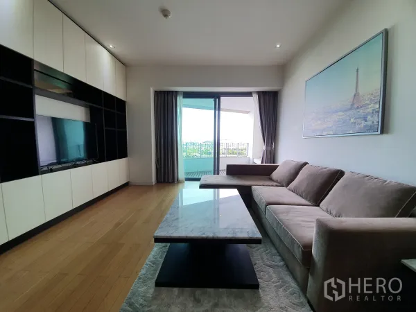 Condominium for rent or sale in Yan Nawa, Bangkok - Living room facing the balcony with river outlook and a marble coffee table.