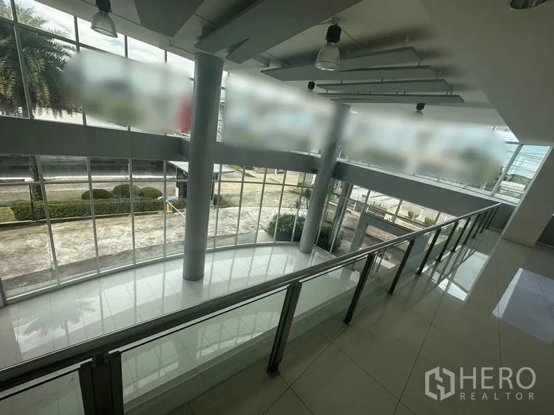Retail Space for rent in Prawet, Bangkok - Mezzanine view over the atrium through a curtain wall of glass with landscaped frontage outside.