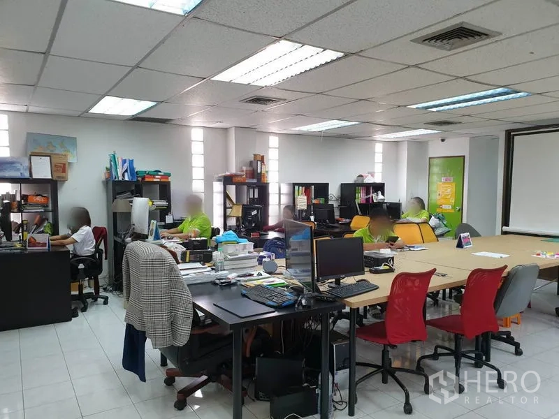 Office Space for rent in Bang Kapi, Bangkok - Spacious workspace with multiple workstations, shelving and tiled flooring in an open-plan layout.