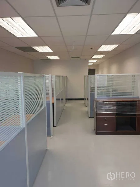 Office Space for rent in Chatuchak, Bangkok - Row of light-filled workstations divided by glass partitions.