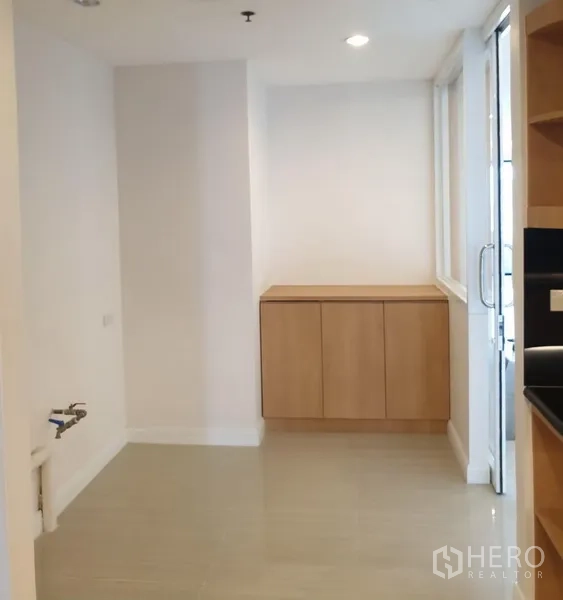 Condominium for rent in Watthana, Bangkok - Bright utility area off the kitchen with storage cabinet, laundry hookups and a glass door to the balcony.