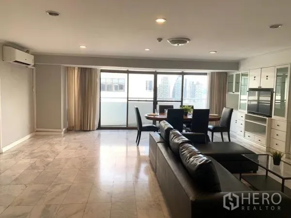 Condominium for rent - Large living space with marble flooring, full-width windows, sofa, and dining area.