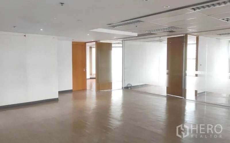 Office Space for rent in Bang Rak, Bangkok - Spacious Bangkok office floor featuring sliding glass walls, wooden doors and bright ceiling lighting.