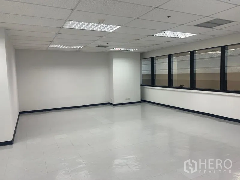 办公空间 出租在Watthana, Bangkok - 大面积开放办公区，瓷砖地面与一排宽窗采光充足。