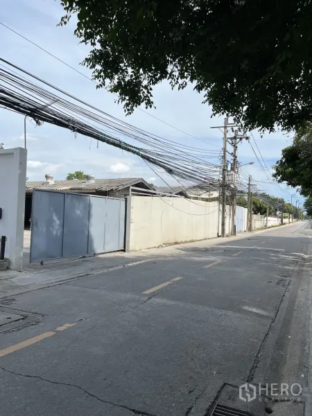 货栈 出租在Bangkok - 临街视角，带大门的仓库入口与安静道路。