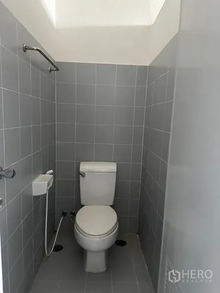 工厂 出租在Pathum Thani - 独立厕所隔间，带喷枪，灰色墙砖。