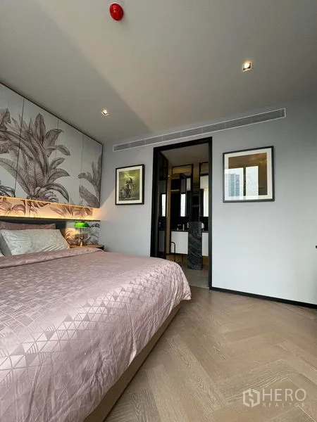 Condominium for rent in Watthana, Bangkok - Primary bedroom looking toward the ensuite bathroom and vanity.