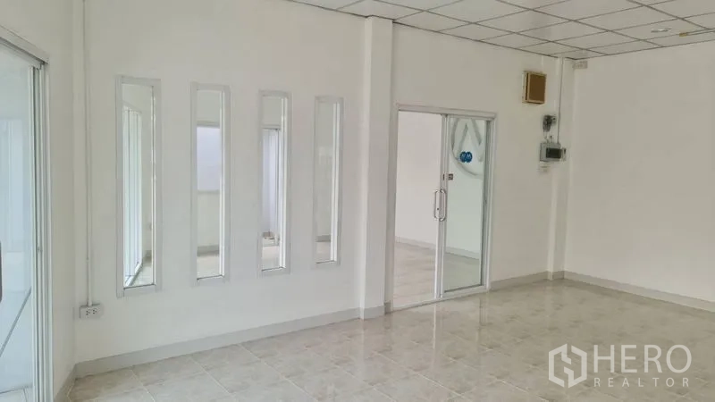 Shophouse for rent - Interior angle showing vertical mirror panels and glass partition door