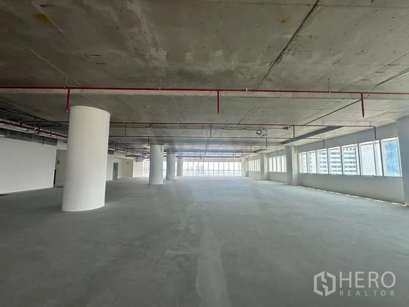 Office Space for rent in Sathon, Bangkok - Expansive workspace with round structural columns, exposed services and window-lined walls in a Bangkok office tower.