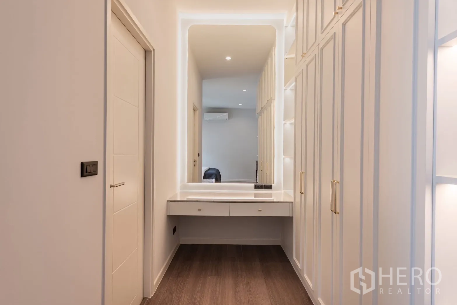Detached House for rent or sale in Bang Phli, Samut Prakan - Dressing corridor with backlit vanity mirror and custom cabinetry.