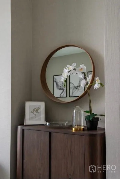 คอนโด ให้เช่า - คอนโซลทางเข้าพร้อมกระจกเงากลม กล้วยไม้ และกรอบรูป