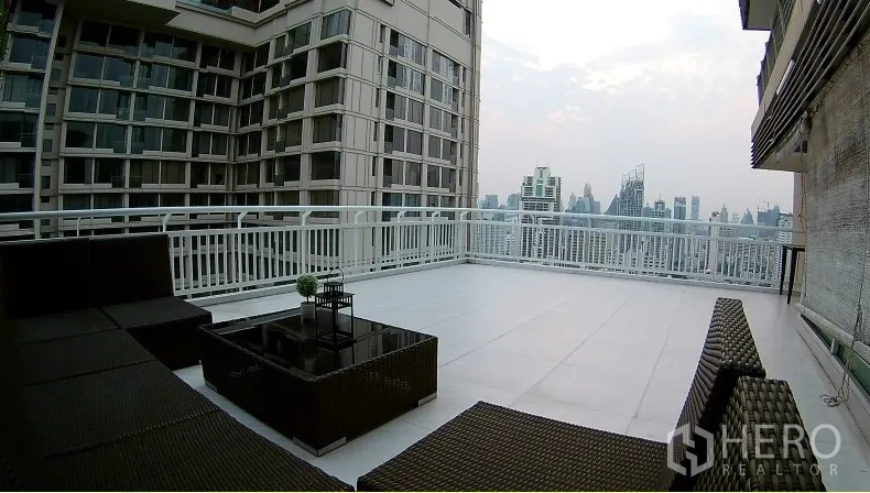 Condominium for rent or sale in Watthana, Bangkok - Large wraparound terrace with outdoor lounge and panoramic Bangkok city view.