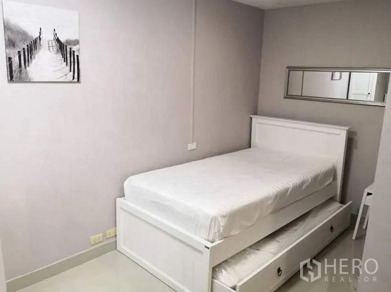 คอนโด ให้เช่าในKhlong Toei, Bangkok - ห้องนอนรับแขกเตียงทรันเดิลสีขาวและกระจกเงายาว