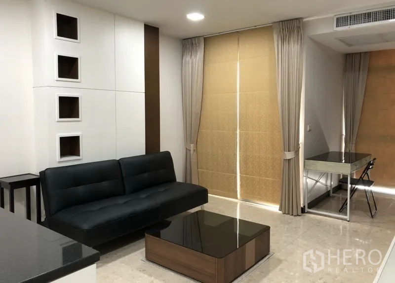 คอนโด ให้เช่าในKhlong Toei, Bangkok - ห้องนั่งเล่นสว่าง โซฟาหนังสีดำ โต๊ะกลาง และผ้าม่านสูงจรดเพดาน
