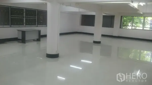 Office Space for rent in Sathon, Bangkok - Bright open-plan office floor with glossy white tiles, columns, and multiple windows.