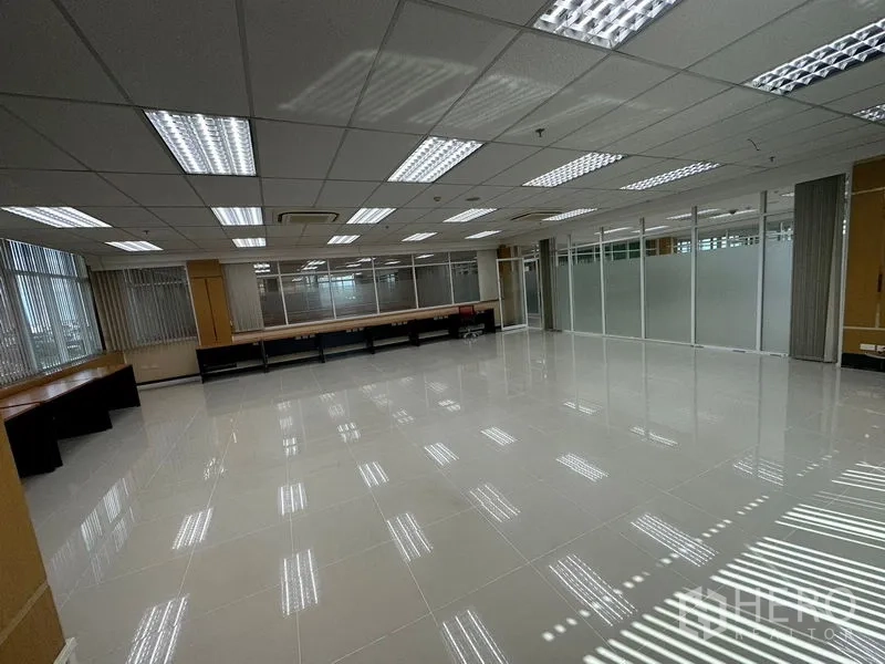Office Space for rent in Suan Luang, Bangkok - Spacious open-plan office with glossy floor, LED grid lighting, and glass partitions.