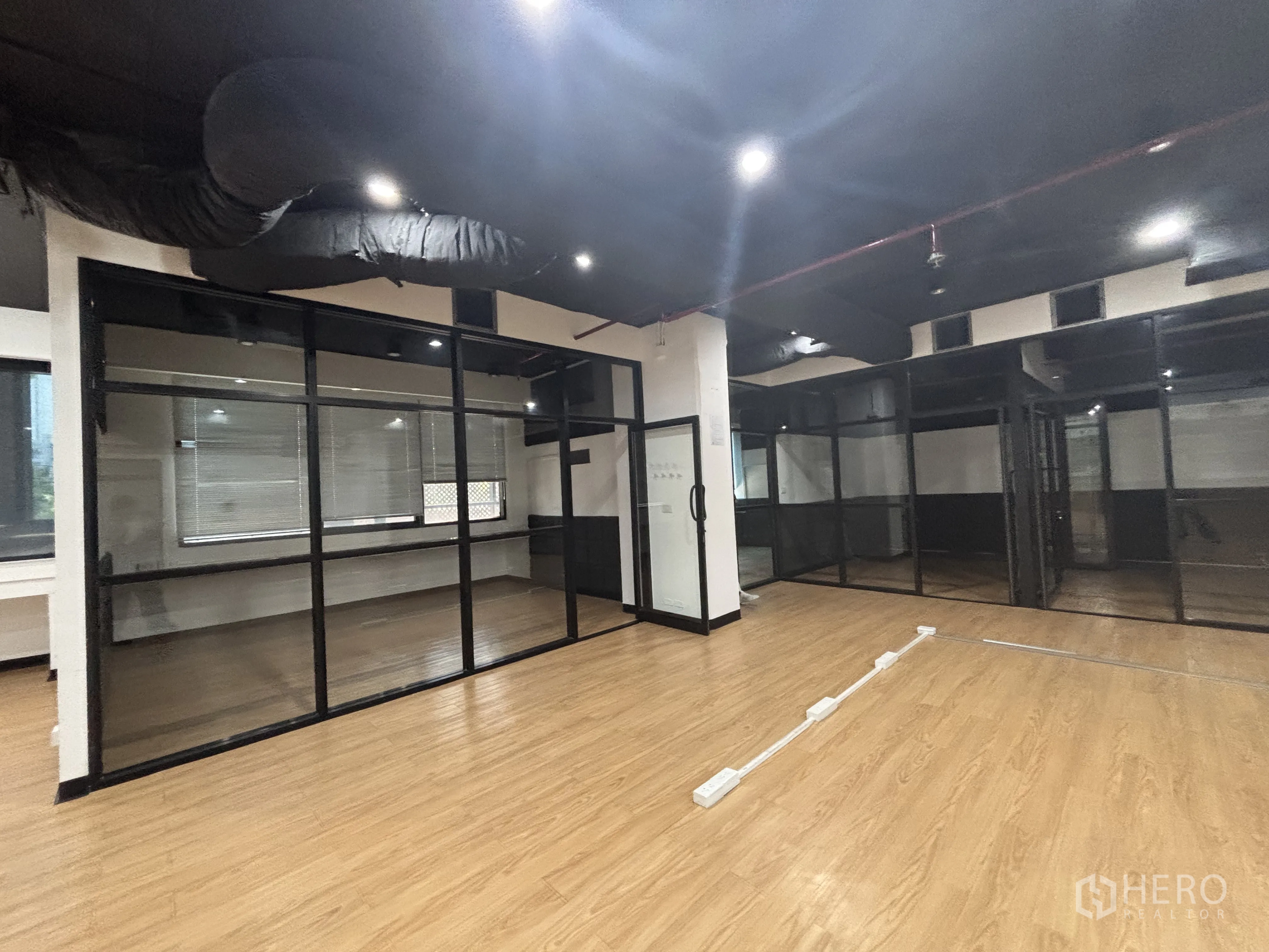 Office Space for rent in Bang Rak, Bangkok - Open workspace with glass partitions, floor cable trunking, and ceiling lighting.