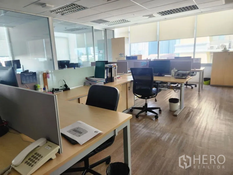 Office Space for rent in Watthana, Bangkok - Spacious open office with partitioned desks, wood floors and ceiling grid lighting.