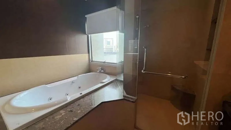 อพาร์ทเมนท์ ให้เช่าในPathum Wan, Bangkok - ห้องน้ำพร้อมอ่างอาบน้ำจากุซซี่ริมหน้าต่าง และตู้ shower กระจกแยกส่วน