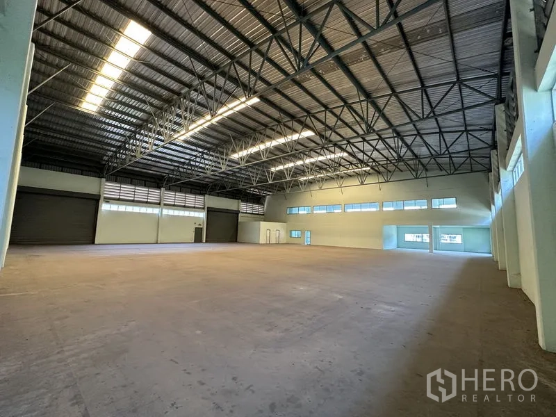 โรงงาน ให้เช่าในChon Buri - พื้นที่การผลิตขนาดใหญ่ มีประตูม้วนหลายจุดและเพดานโครงเหล็กเปิดโล่ง