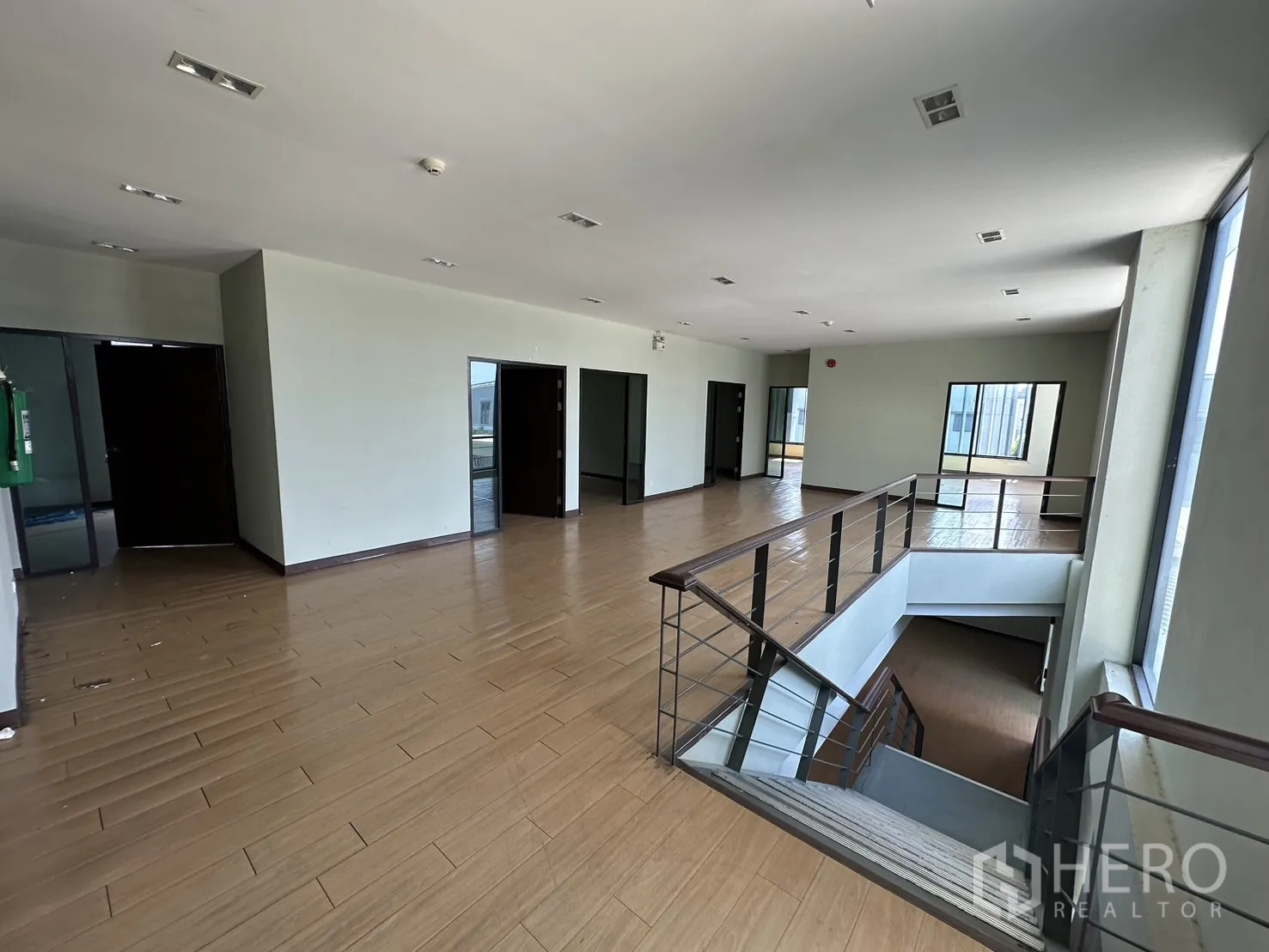 Home Office for rent in Prawet, Bangkok - Upper-floor landing with staircase, wide hall and multiple room entrances.