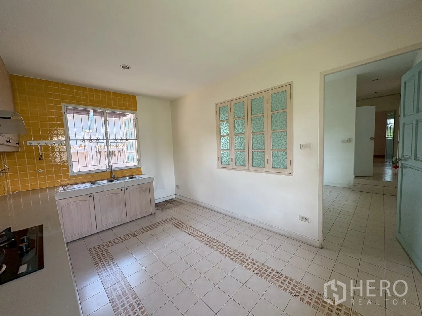 บ้าน ขายในPhra Khanong, Bangkok - ครัวยกระดับ ผนังกระเบื้องสีเหลือง ซิงก์คู่ และหน้าต่าง