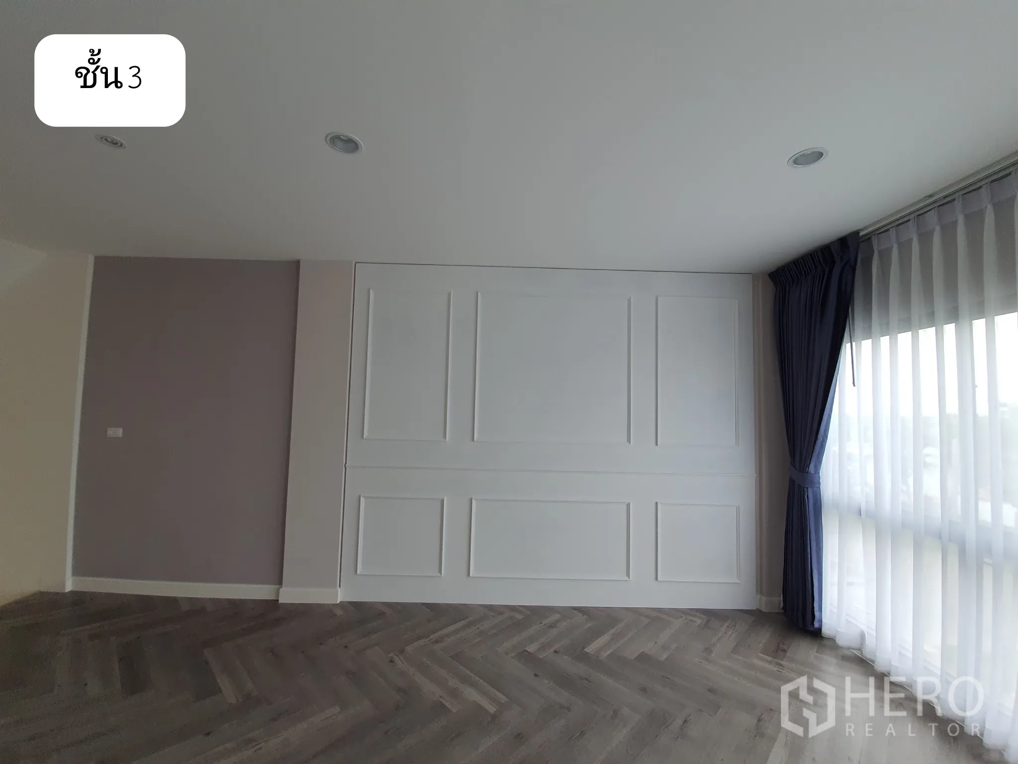 Home Office for rent or sale in Prawet, Bangkok - Third-floor lounge or meeting area with white wall paneling, sheer curtains and dark herringbone floor.