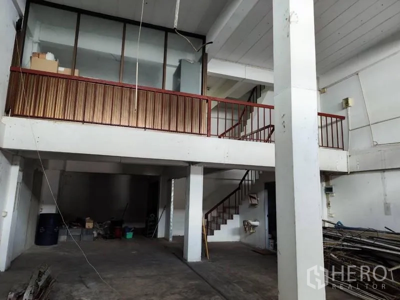 Shophouse for sale in Pathum Thani - Industrial hall showing mezzanine level and side stairwell.