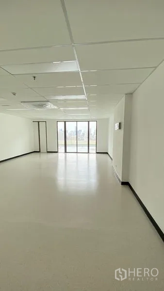 Office Space for rent in Watthana, Bangkok - Open 49 sqm office with large end windows bringing natural light into the workspace.