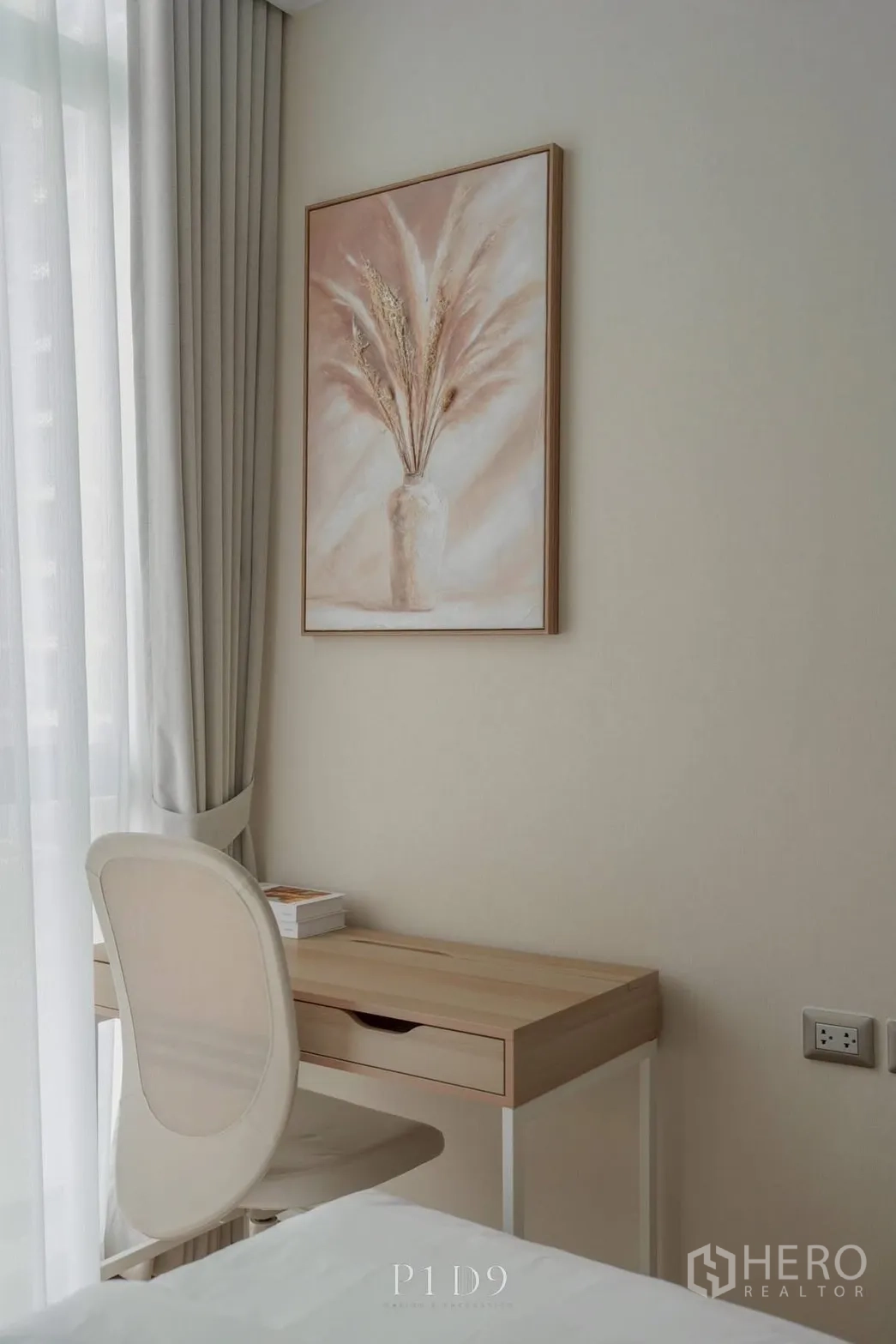 Condominium for rent in Watthana, Bangkok - Cozy workspace by the window with a light wood desk, chair, and artwork.
