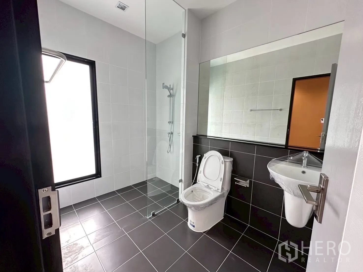 สำนักงานที่บ้าน for rent in Lat Phrao, Bangkok - ห้องน้ำสว่าง มีฉากกั้นอาบน้ำกระจก กระจกบานใหญ่ และกระเบื้องขาวดำ.