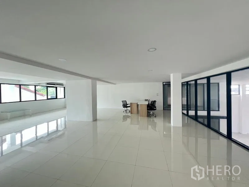 Office Space for rent or sale in Wang Thonglang, Bangkok - Spacious office level with glass partitions and workstations.