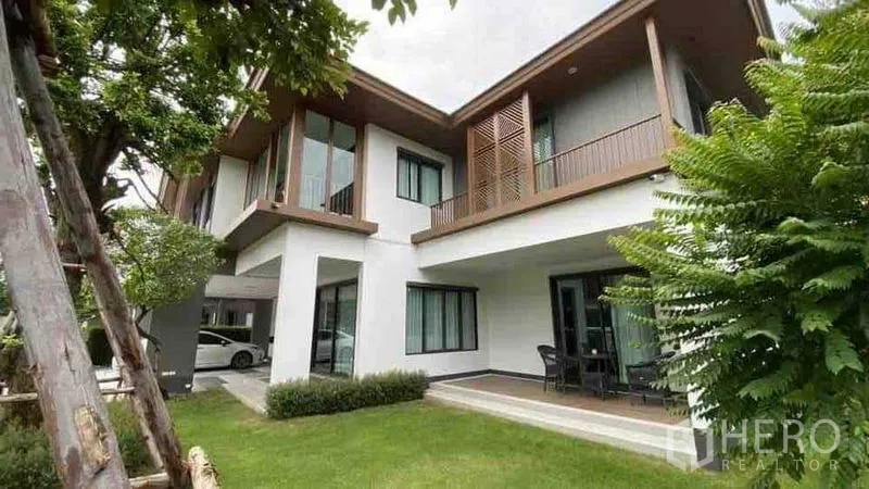 Detached House for rent or sale in Prawet, Bangkok - Rear garden with covered terrace, upstairs balcony and mature trees.