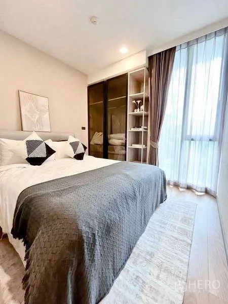 คอนโด ให้เช่าในWatthana, Bangkok - ห้องนอนหลักสว่างโปร่ง มีหน้าต่างเต็มผนัง ผ้าม่านโปร่ง และตู้เสื้อผ้าบานกระจก