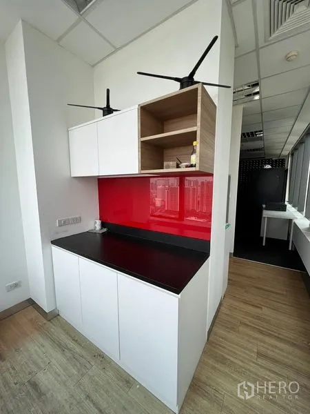 Office Space for rent in Huai Khwang, Bangkok - Pantry with white cabinetry, red splashback and a black countertop.
