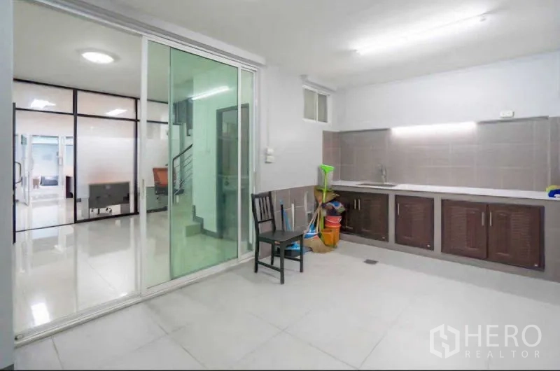 Home Office for rent or sale in Lat Krabang, Bangkok - Rear pantry with long countertop and sliding glass door.