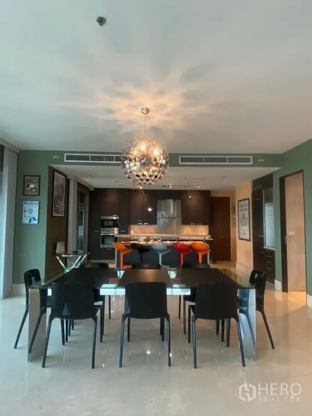 公寓 出租在Watthana, Bangkok - 餐区配设计感吊灯，邻近简约开放式厨房。